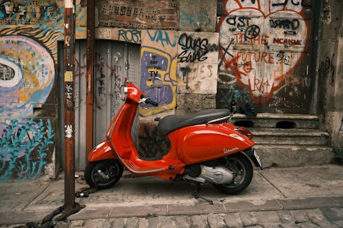 Free Red Scooter Park on the Side of the Street Stock Photo