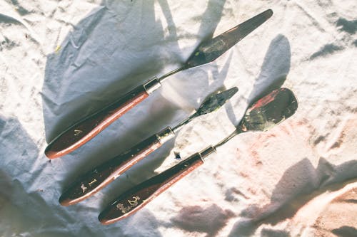 Three Brown Wooden Handled Tools