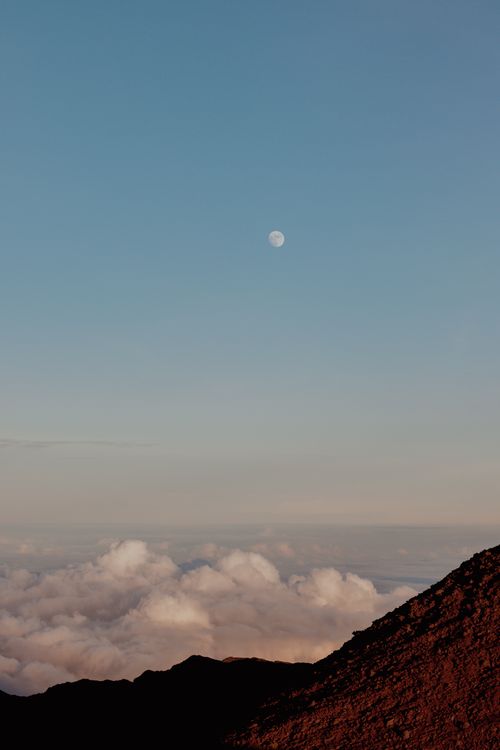 Free Beautiful night sky with moon over mountain peak and clouds. Stock Photo