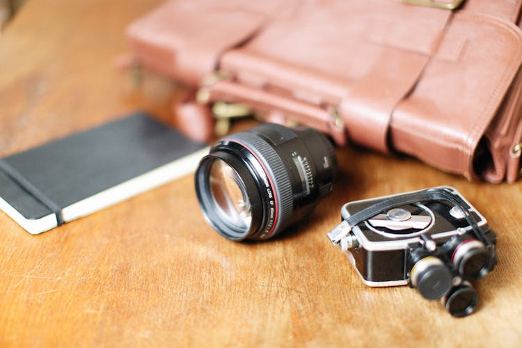 Camera Lens, Notebook And Bag