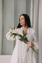 Girl in White Dress Holding White Lily