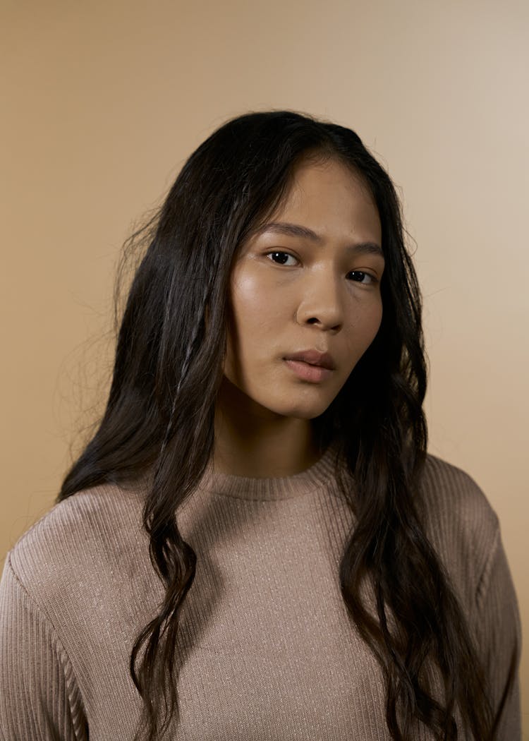 Portrait Of A Woman In Brown Shirt