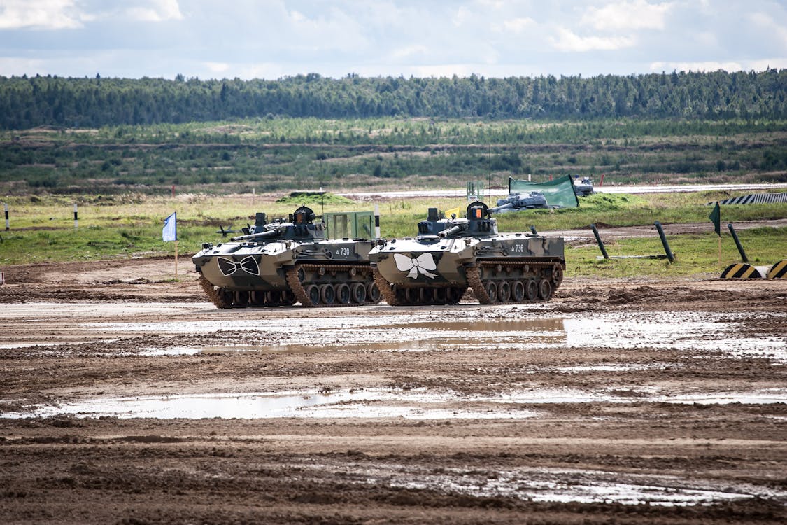 Free Military Tanks on a Muddy Field Stock Photo