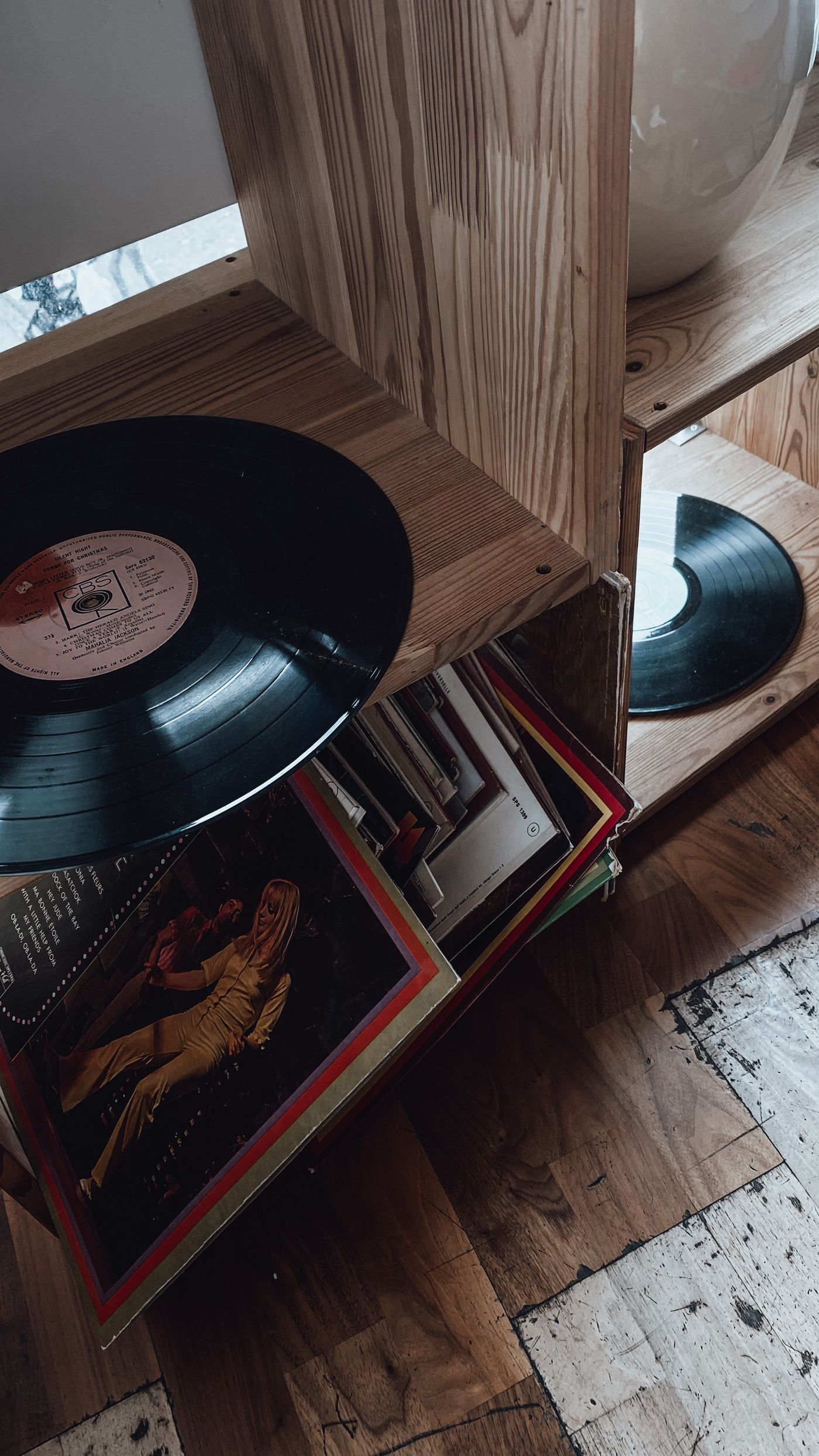 Vinyl records on a wooden shop shelf