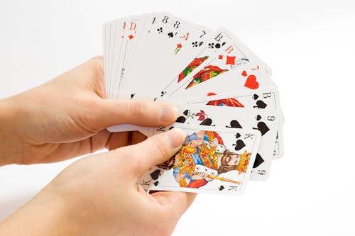 Person Holding Playing Cards