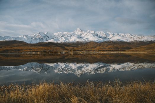 Stunning Panorama of Snow Capped Mountains Reflecting in Lake