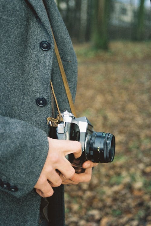 Person Holding Digital Camera Outside 