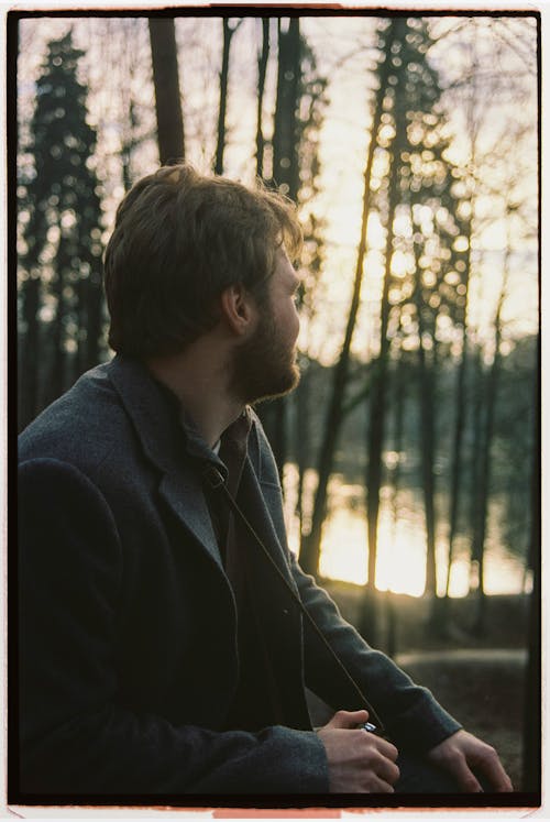 Man in Black Blazer Standing near Trees