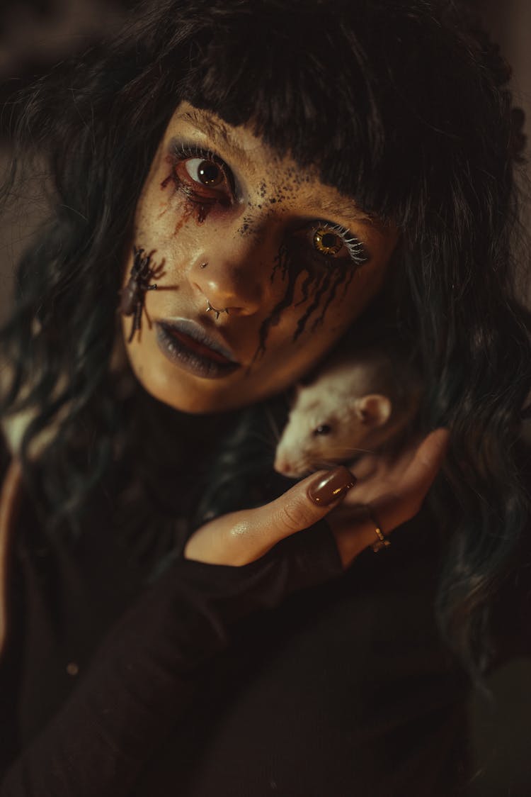 Woman Wearing Creepy Creative Makeup Holding A Mouse