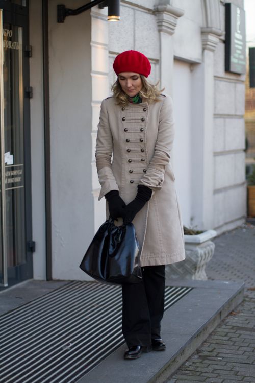 Free Woman in a stylish red beret and coat standing outdoors in Kaliningrad. Stock Photo