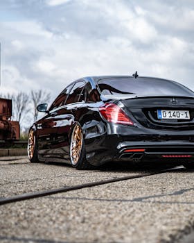 A sleek black luxury sedan parked outdoors in Nuremberg, Germany, showcasing its stylish rear design.