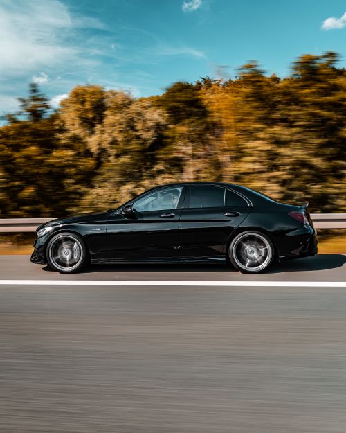 Free Experience the sleekness of a black car speeding down a German highway, capturing the essence of motion and design. Stock Photo