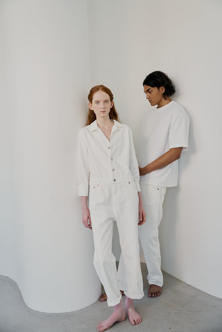 Man In White Shirt Standing Beside A Woman In White Long Sleeve Shirt