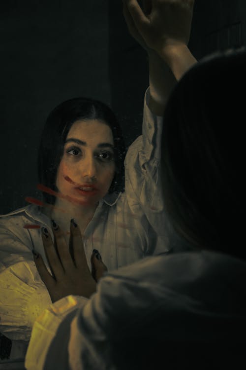 Woman in White Dress Shirt Looking in the Mirror 