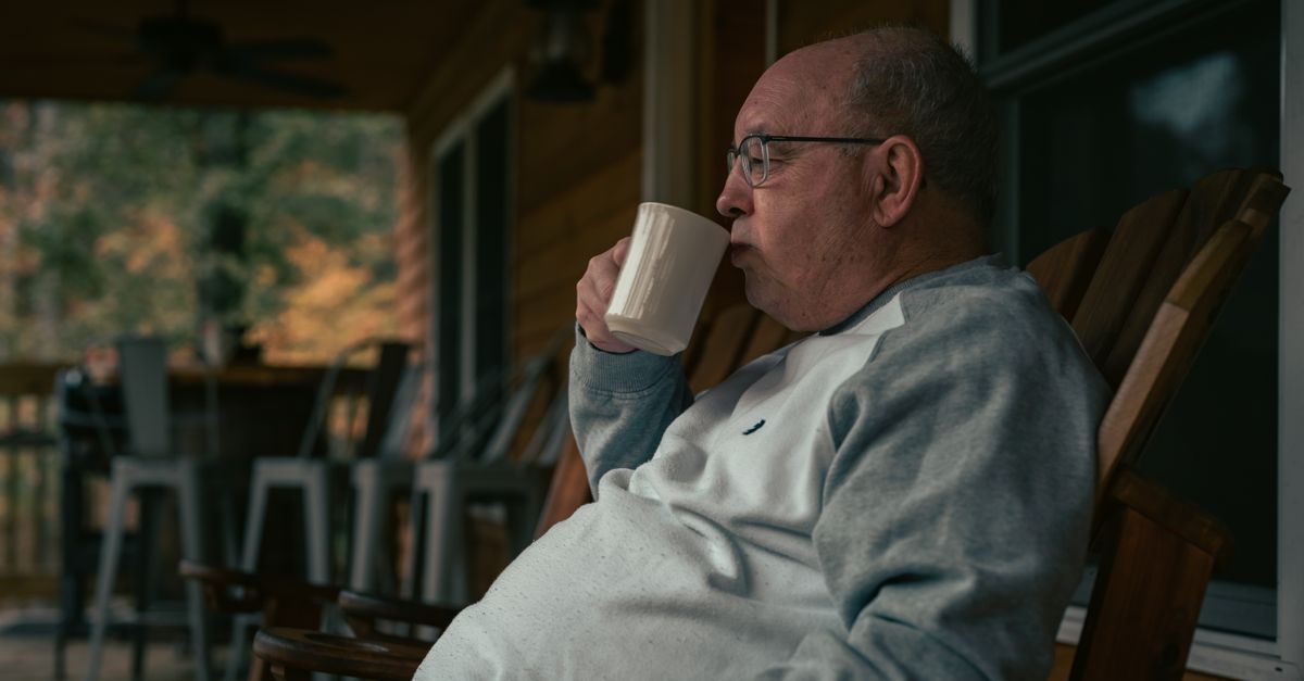 person sitting on porch with coffee, morning light, no phone in hand