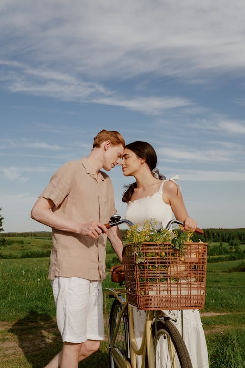 Free Man in Brown Button Down Shirt Beside Woman in White Dress  Stock Photo