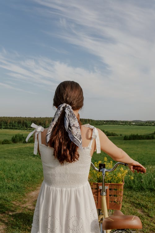 Rear View on Woman in Dress with Bicycle