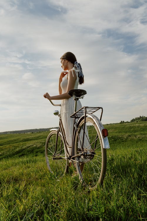 Woman in White Dress with Bicycle