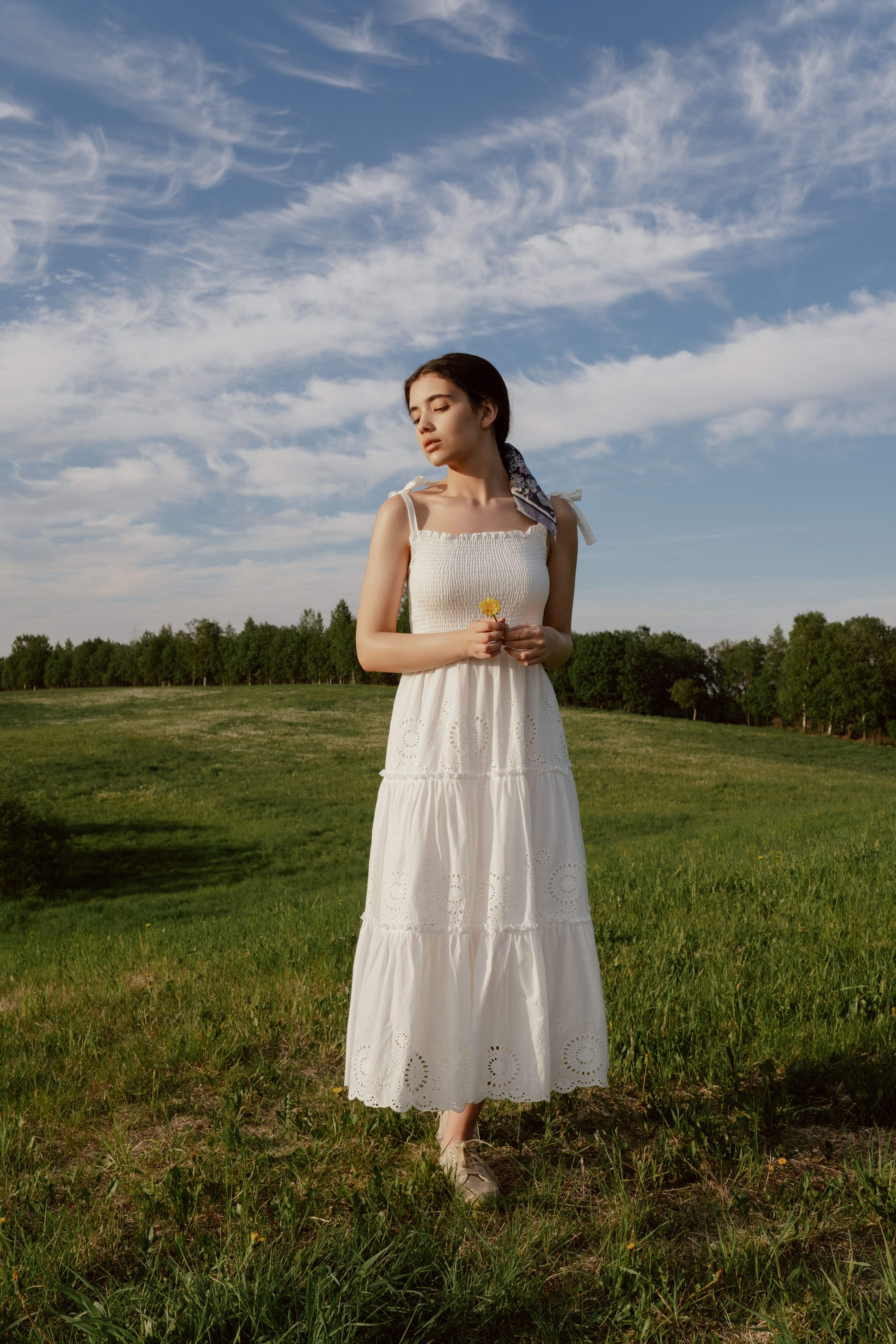 Woman wearing a smocked sundress with block heels