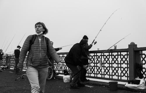 Grayscale Photo of People Fishing on the River