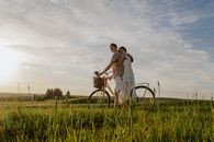 Man and Woman Wheeling a Bicycle and Hugging