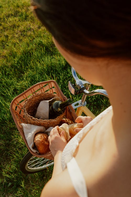 Woman Looking at Picnic Basket from Above