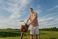Man with a Bicycle on a Meadow