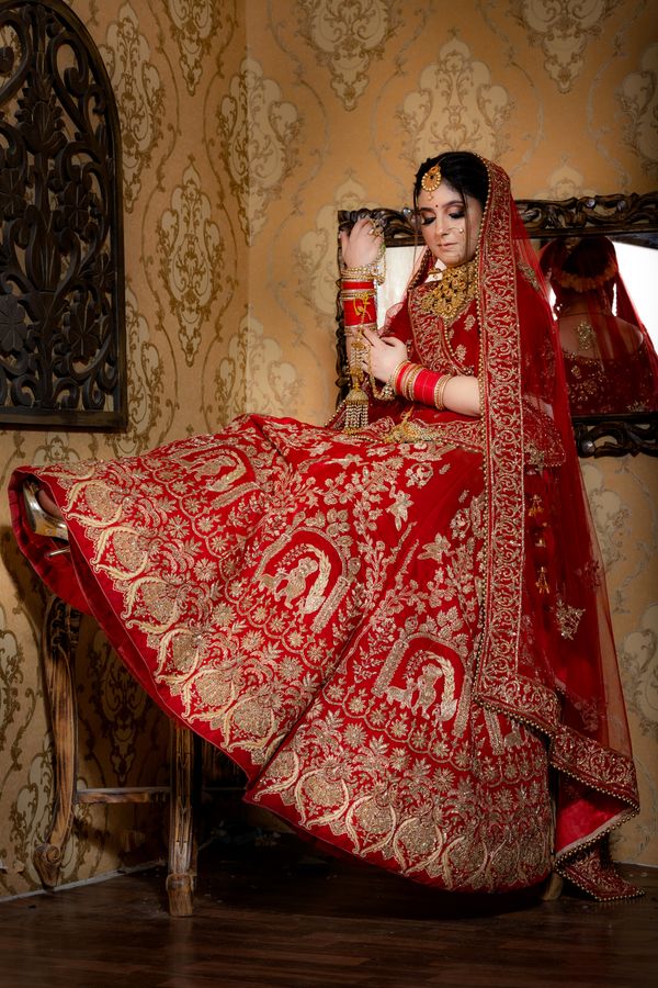 Bride in red embroidered lehenga