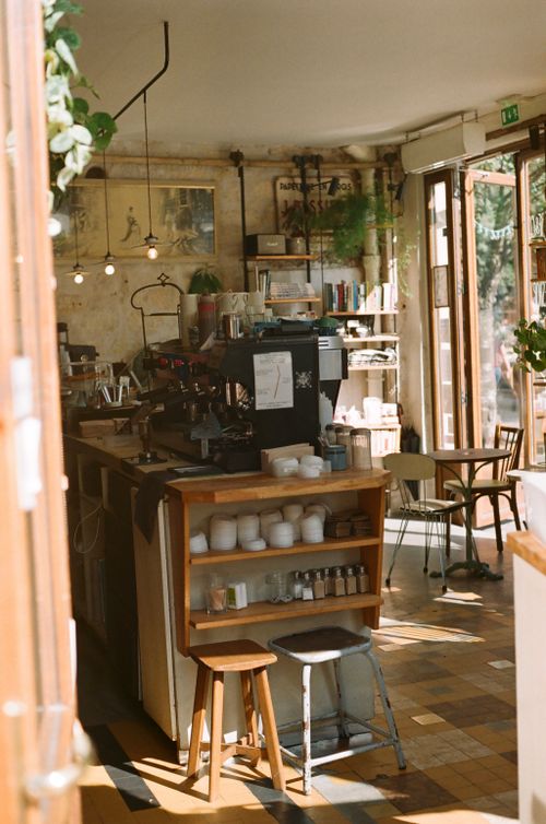Free Charming interior of a rustic coffee shop with warm natural lighting and vintage decor. Stock Photo