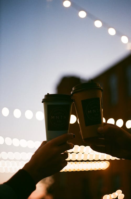 Hands Holding Coffee Cups