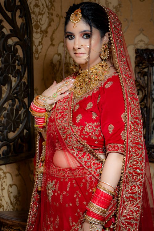 Free Photo of a Woman Wearing Red and Gold Traditional Clothes Stock Photo