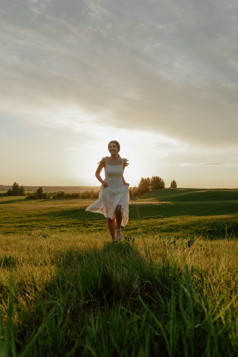 Woman in White Dress Running Through Meadow at Sunset · Free Stock Photo