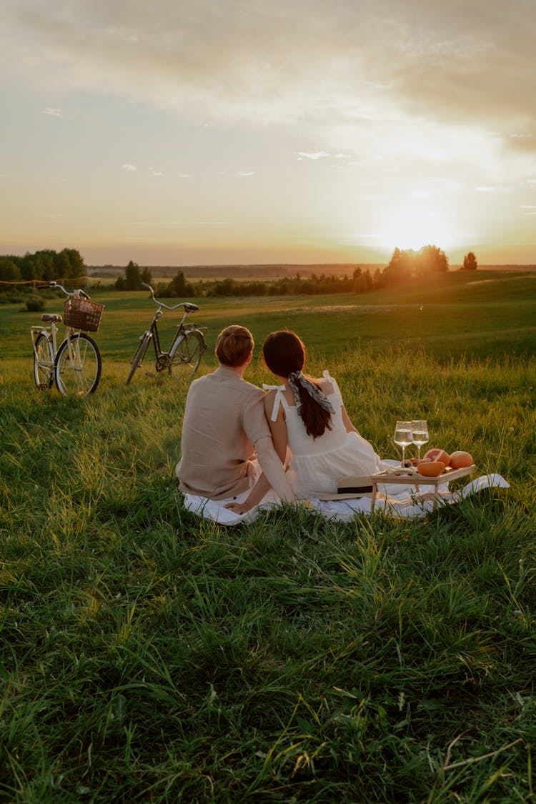 Back View Of A Couple Looking At The Sunset