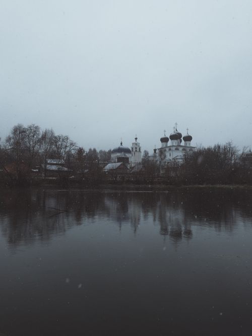 Free Peaceful view of a church with onion domes reflecting in a tranquil lake in Kirov, Russia. Stock Photo