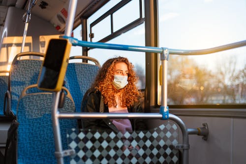 Free Photo of a Woman with Red Curly Hair Sitting in a Bus Stock Photo