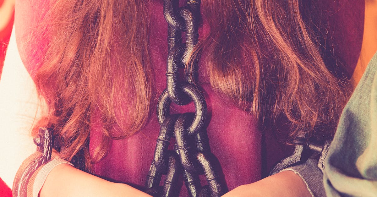 Woman in Maroon Shirt With Black Chain on Her Body