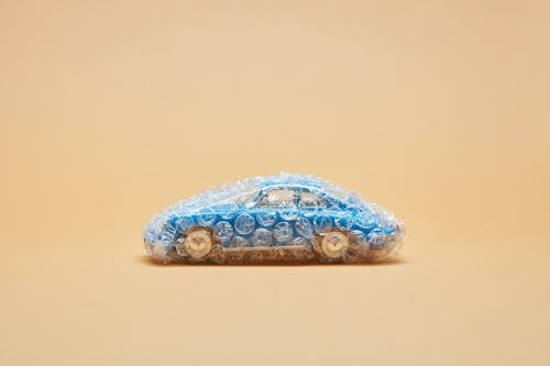 Blue Toy Car Covered with Bubble Wrap