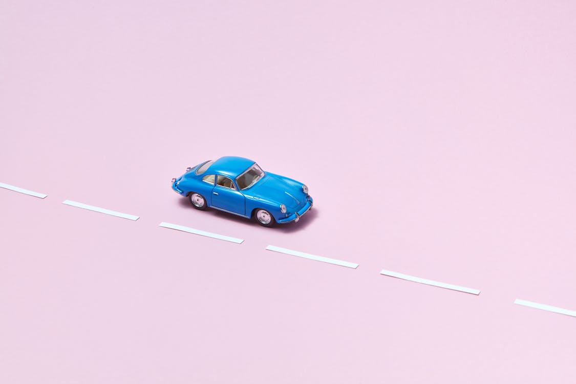 Toy Coupe Car on Pink Background