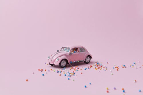 Free Pink Toy Car on Pink Background Stock Photo