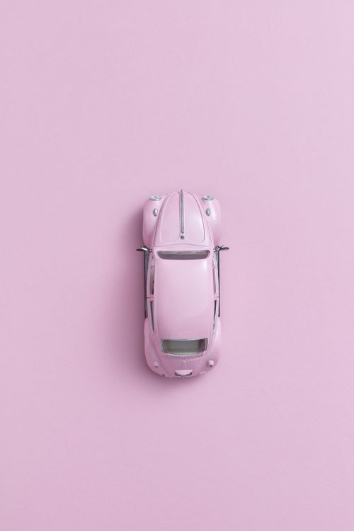 Free Overhead shot of a pink toy car on a pastel pink background, perfect for modern design. Stock Photo