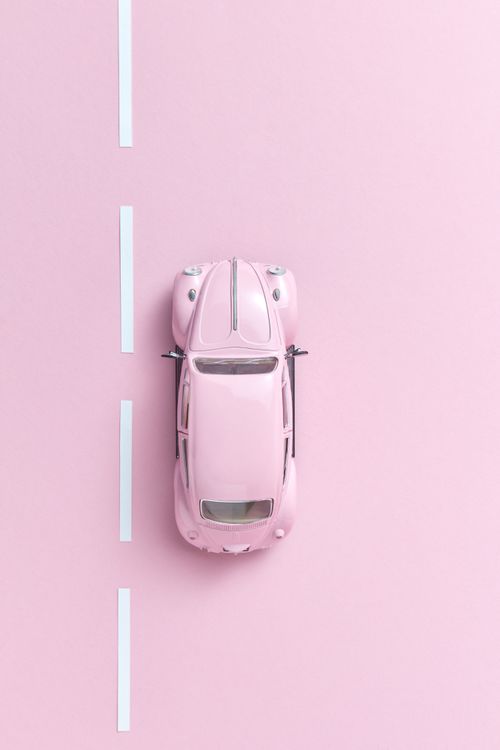 Free Overhead shot of a pink toy car on a pastel background, ideal for creativity themes. Stock Photo