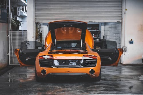 Free Orange Car Parked in the Garage Stock Photo