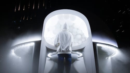 Free Person in White Hoodie Standing Near a UFO Stock Photo