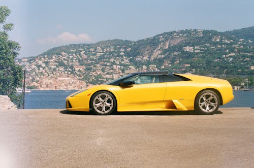 Free Yellow Sports Car Parked on Riverside Stock Photo