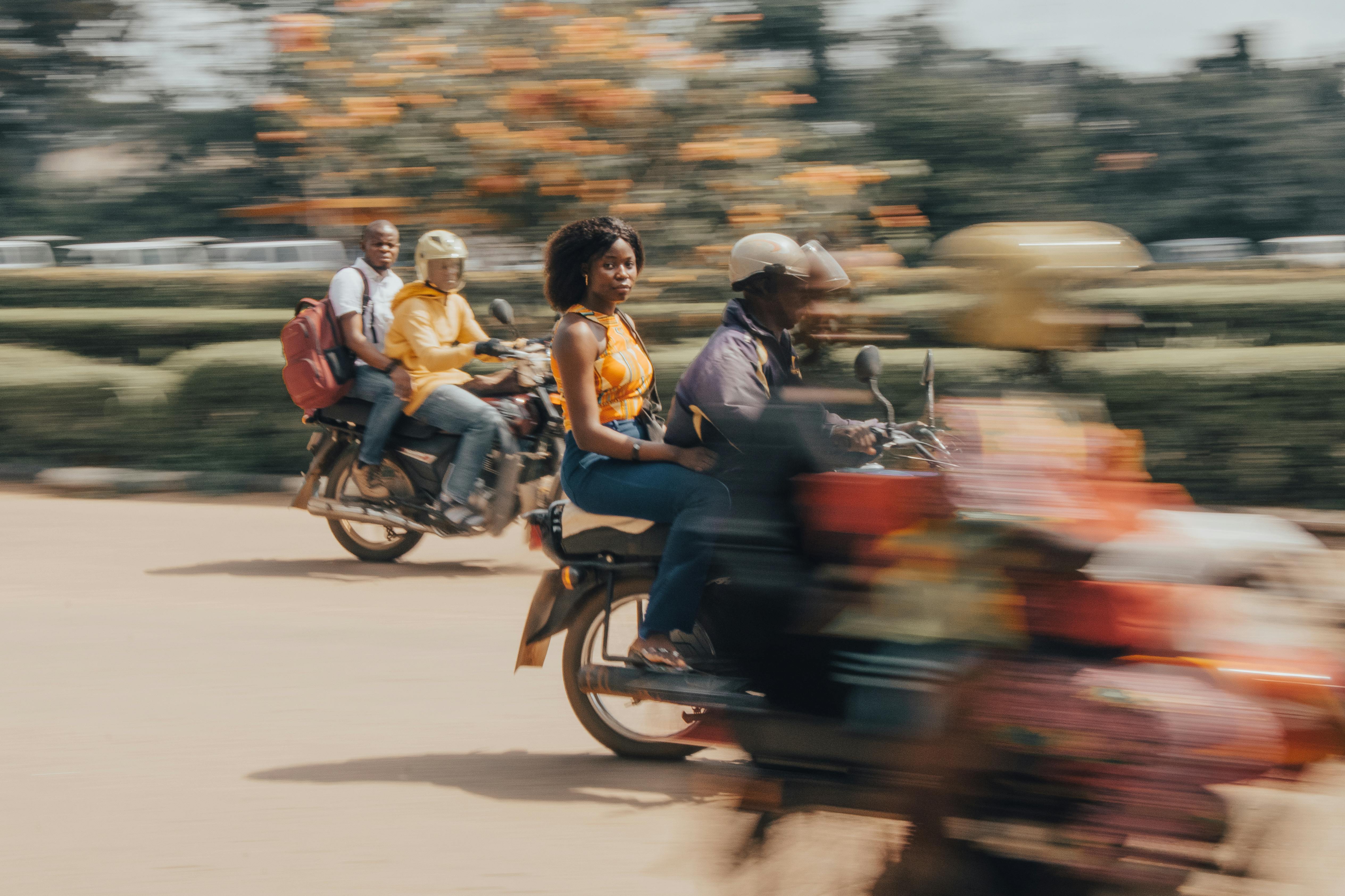 Vibrant street photo of people riding motorcycles in motion. Captures urban life.