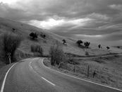 Grayscale Photo of Road and Mountains