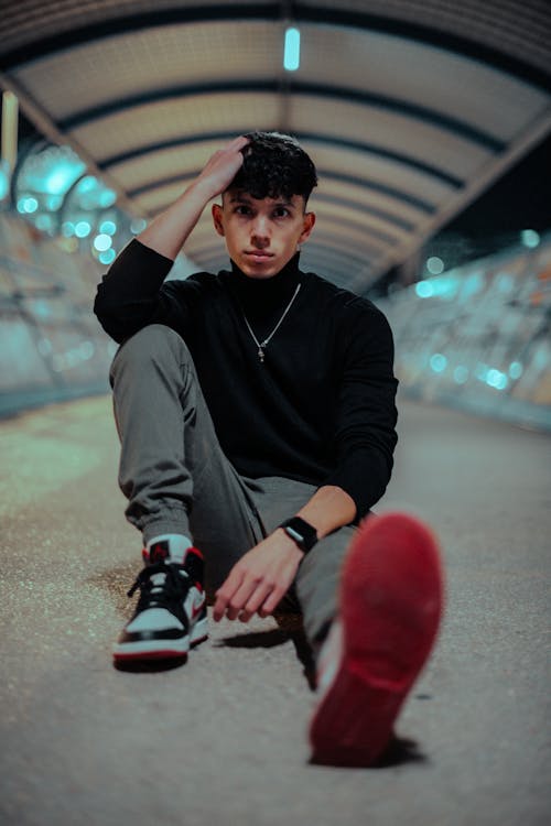 Man in Black Long Sleeve Shirt Sitting on the Floor