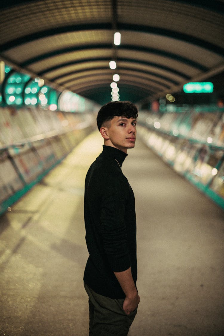 Man In Black Turtle Neck Long Sleeves Standing On Hallway