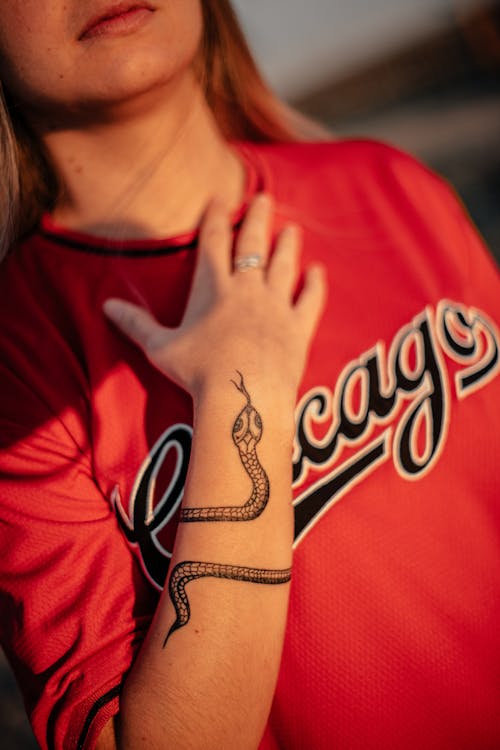 A Woman in Red Shirt with Tattoo on Her Hand