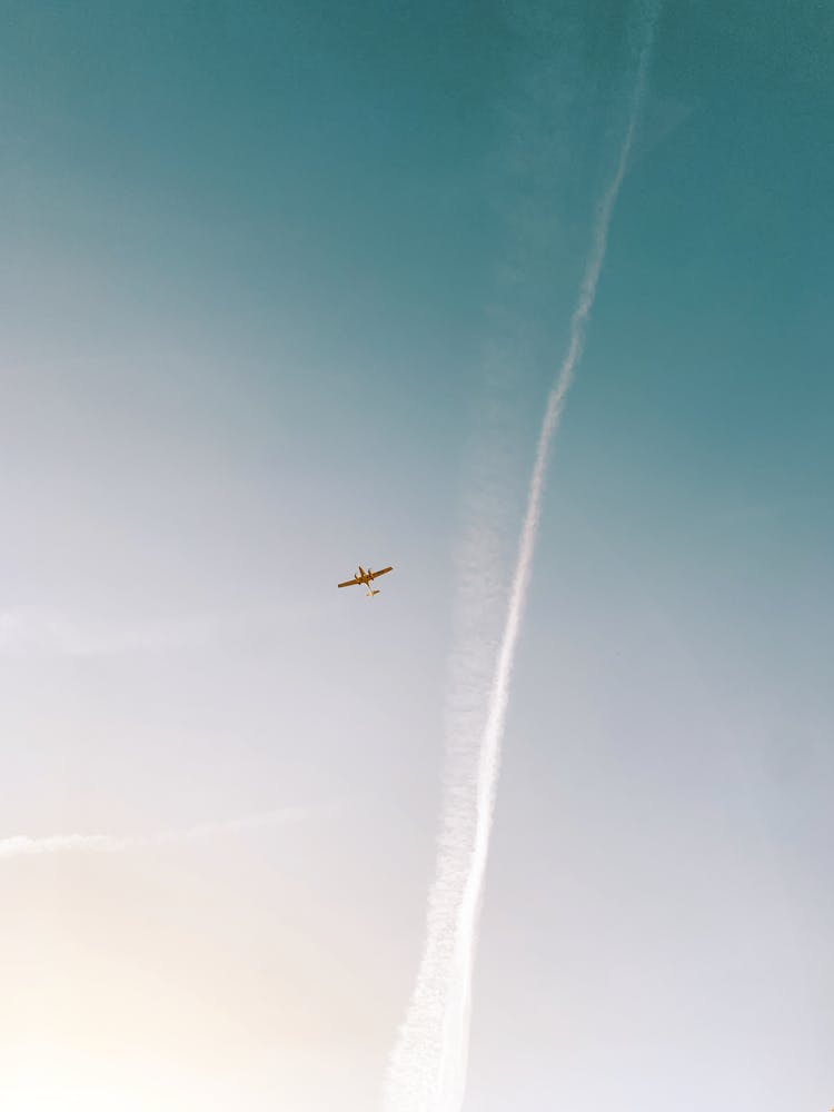 An Aircraft And Contrail In The Sky